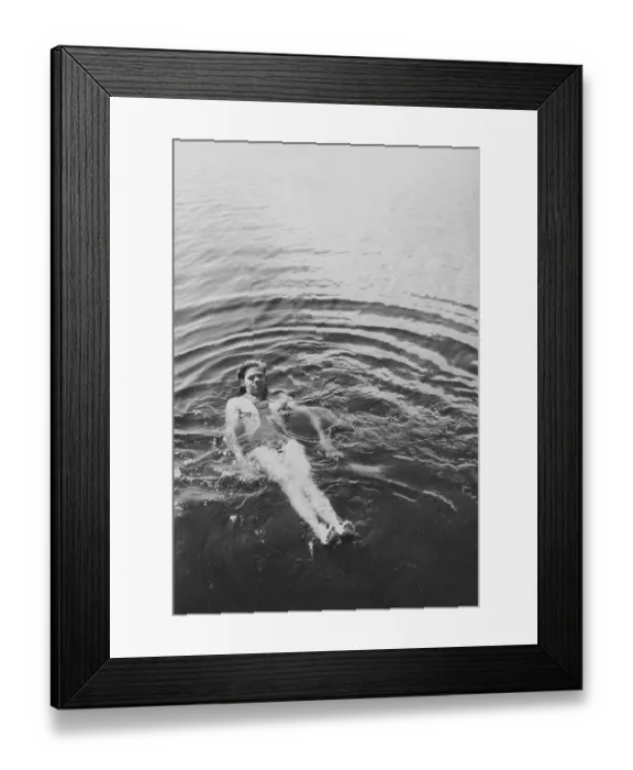 Framed Print : Having fun in the 1930s. A young man is having a swim Framed Print : Having fun in the 1930s. A young man is having a swim