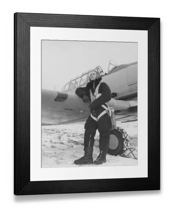 Framed Print : Pilot in the 1950s. A swedish pilot beside his aircraft a winter day. Sweden 1950s