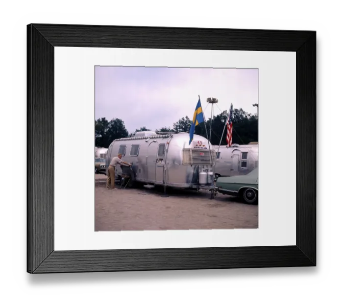 Framed Print : 1970s camping. Pictured an American Airstream caravan in aluminium and in the typical 1930s streamline design Framed Print : 1970s camping. Pictured an American Airstream caravan in aluminium and in the typical 1930s streamline design