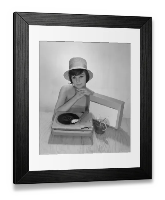 Framed Print : 1960s lifestyle. A young woman with a Philips radio and a gramophone as it could look in the summer