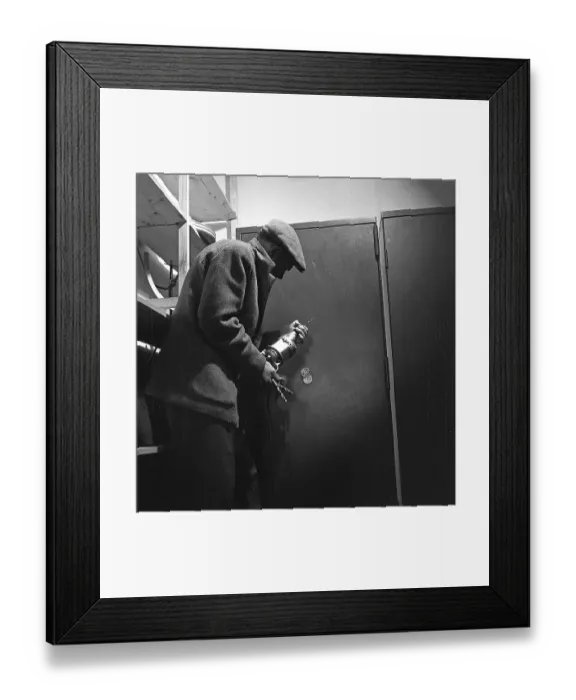 Framed Print : Crime in the 1960s. An arranged picture featuring a man preparing to break into a safe