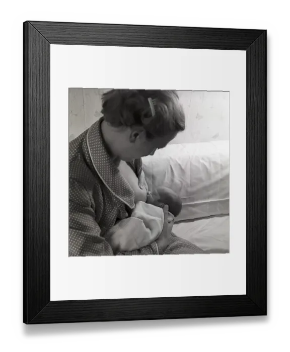 Framed Print : 1950s mother nursing her baby. A young woman breastfeeding her baby at home. Sweden 1951 Neg CV / 24