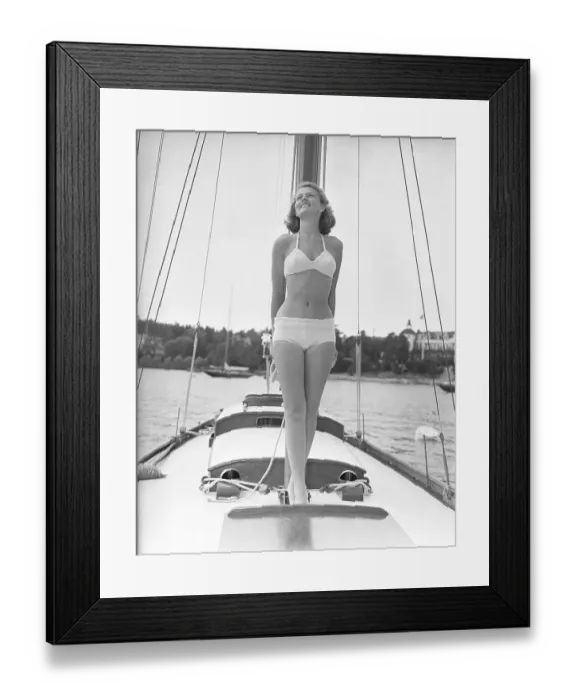 Framed Print : 1940s bikinifashion. A swedish young woman in a white bikini on a sailing boat on a summer's day