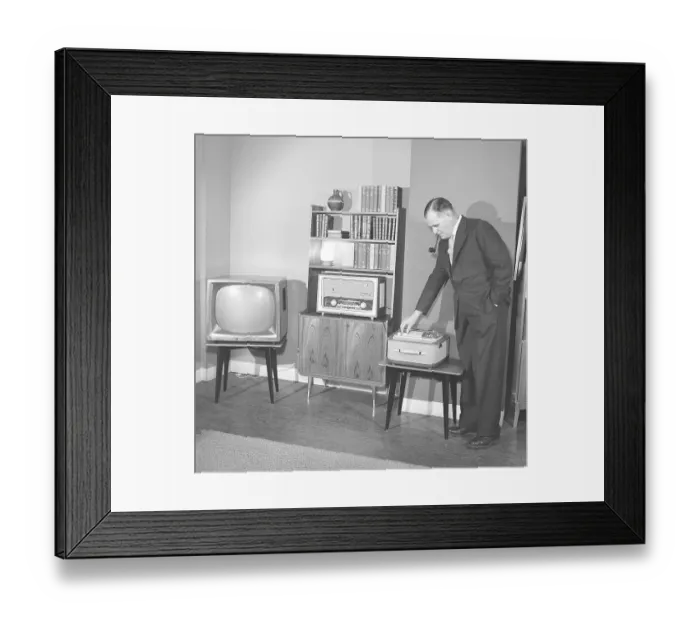 Framed Print : Television in the 1950s. A proud elderly man is pictured in his home with the latest in electronic home equipment Framed Print : Television in the 1950s. A proud elderly man is pictured in his home with the latest in electronic home equipment