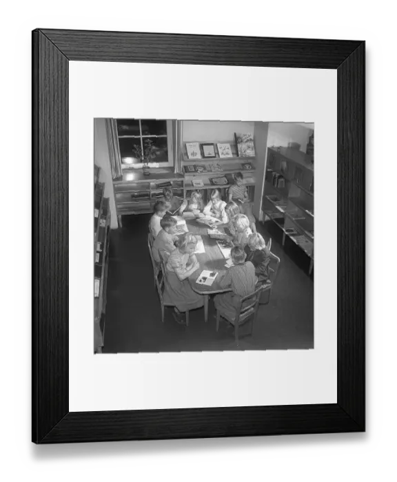 Framed Print : Children of the 1950s. Interior of a public library and a room with bookshelves on the walls. A group of children are sitting at a table, all reading a book each. Sweden 1951 Kristoffersson ref BE25-12 Framed Print : Children of the 1950s. Interior of a public library and a room with bookshelves on the walls. A group of children are sitting at a table, all reading a book each. Sweden 1951 Kristoffersson ref BE25-12