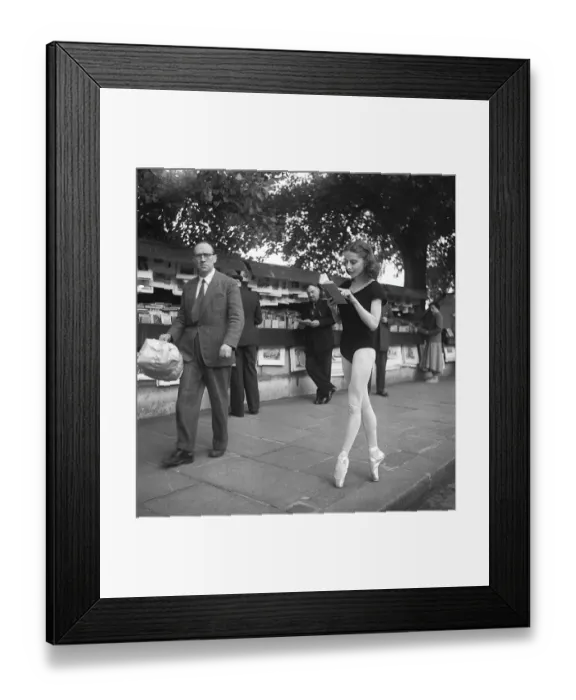 Framed Print : Ballerina in Paris 1952. Ellen Rasch, 1920-2015 pictured in Paris in her dancing outfit standing on her toes reading a book off a street merchants stand. Paris 1952 Kristoffersson ref BD27-7 Framed Print : Ballerina in Paris 1952. Ellen Rasch, 1920-2015 pictured in Paris in her dancing outfit standing on her toes reading a book off a street merchants stand. Paris 1952 Kristoffersson ref BD27-7