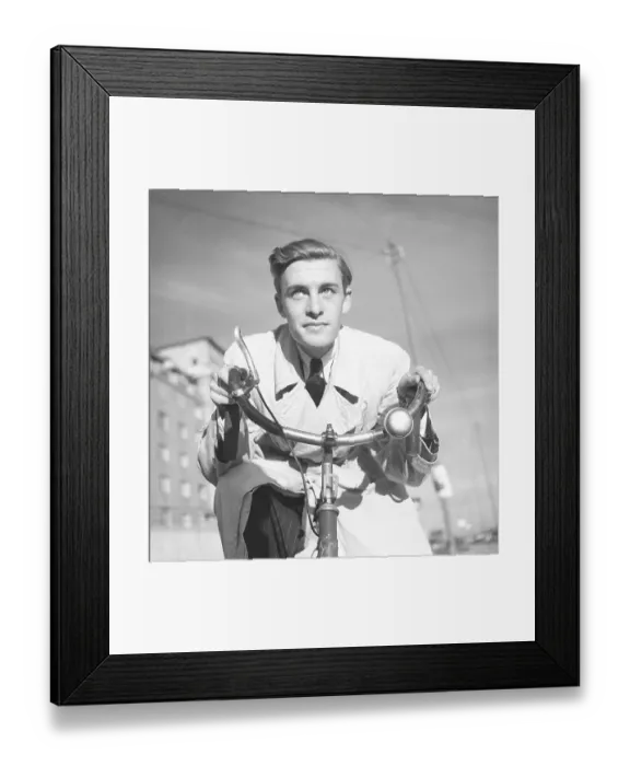 Framed Print : 1940s man on a bicycle. The Swedish actor Alf Kjellin on a bicycle holding the handlebars Framed Print : 1940s man on a bicycle. The Swedish actor Alf Kjellin on a bicycle holding the handlebars