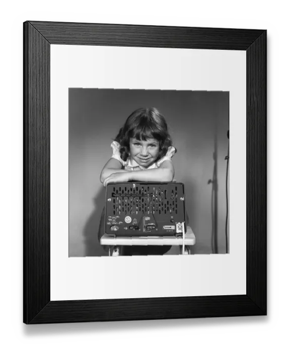 Framed Print : In the 1950s. A girl with a Philips radio set with the backside of the radio visible where the sockets for external