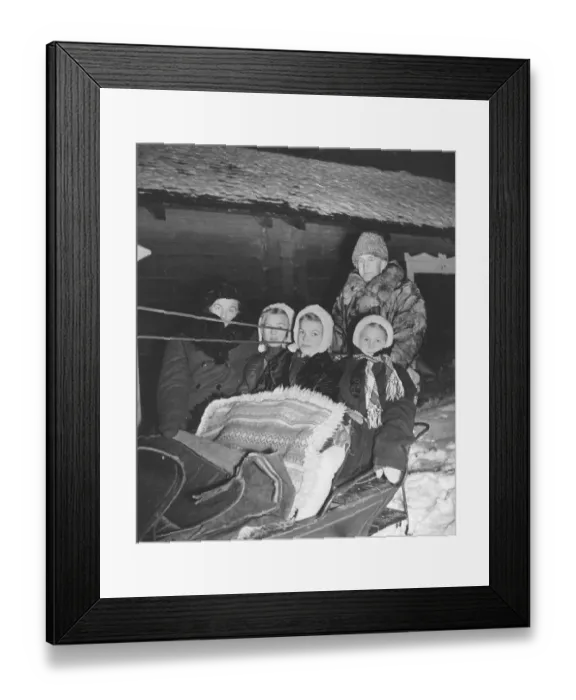 Framed Print : Christmas 1940s. A family is ready to go to the early service in church on christmas morning. A father and his three girls are well dressed for the freezing cold weather. Sweden 1944