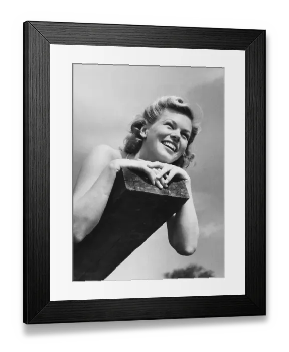 Framed Print : 1950s summer. A young smiling woman lies on a summer day Framed Print : 1950s summer. A young smiling woman lies on a summer day