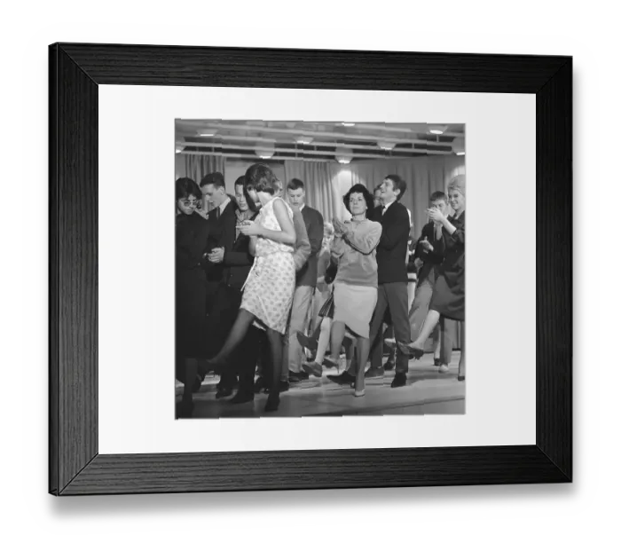 Framed Print : Dancing in the 1960s. The dance Hully Gully is being made popular and here are men and women dancing the new craze. Hully Gully was a type of unstructured line dance and consisted of a series of steps and was relatively simple and easy to execute
