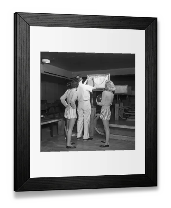Framed Print : Bowling in the 1950s. A man with three young women in a bowling alley