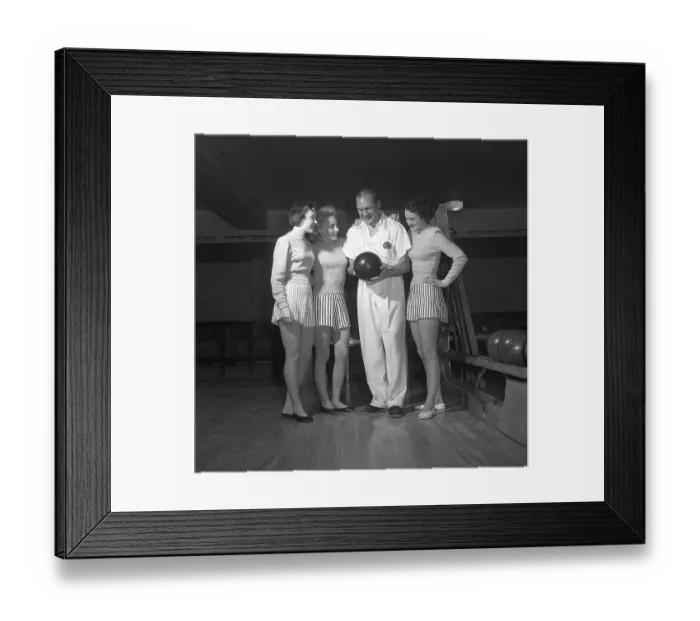 Framed Print : Bowling in the 1950s. A man with three young women in a bowling alley