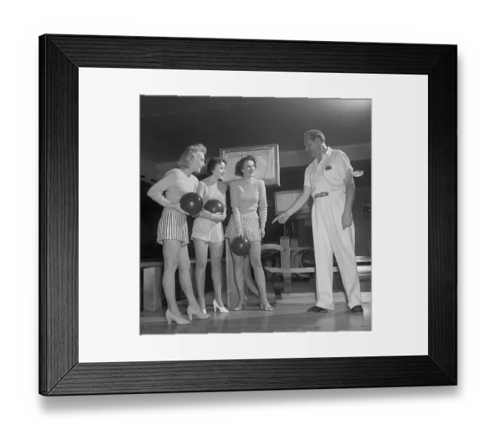 Framed Print : Bowling in the 1950s. A man with three young women in a bowling alley Framed Print : Bowling in the 1950s. A man with three young women in a bowling alley