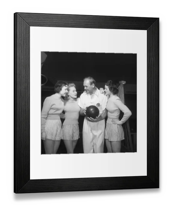 Framed Print : Bowling in the 1950s. A man with three young women in a bowling alley
