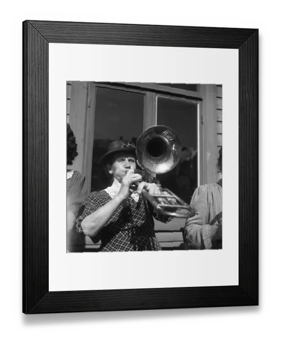Framed Print : 1940s musical woman. A woman in an all-women band is playing the trombone