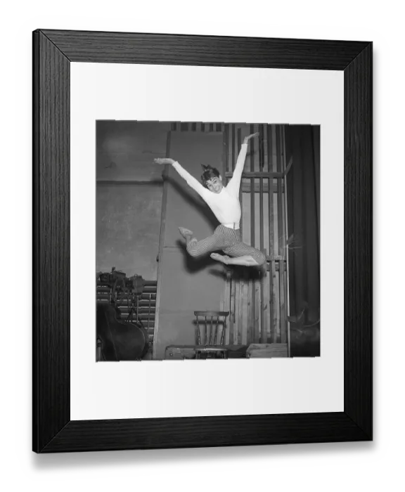 Framed Print : In the 1950s. An unknown young woman is pictured in the moment when being highest in the air having jumped off