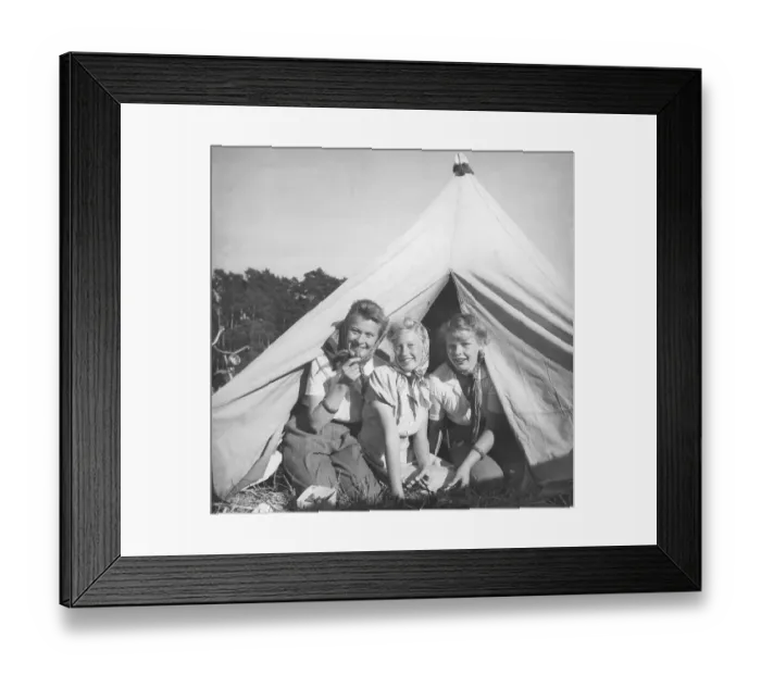 Framed Print : Camping in the 1940s. Three friends are sitting in the entrance of their tent