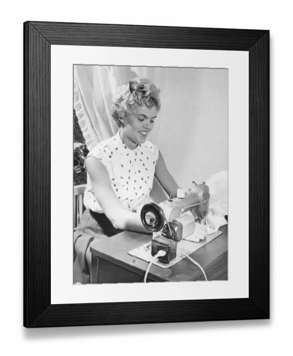 Framed Print : Sewing in the 1950s. Swedish female athlete and high-jump champion Inga-Britt Lorentzon at her sewing machine, a swedish model from manufacturer Husqvarna Framed Print : Sewing in the 1950s. Swedish female athlete and high-jump champion Inga-Britt Lorentzon at her sewing machine, a swedish model from manufacturer Husqvarna