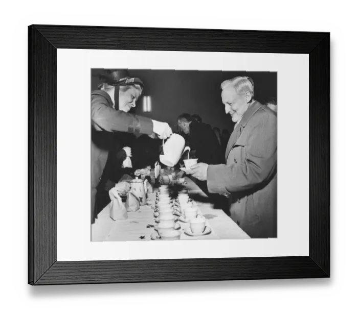 Framed Print : Christmas in the 1950s. A woman from the Salvation Army is serving a homeless man coffee at christmas Framed Print : Christmas in the 1950s. A woman from the Salvation Army is serving a homeless man coffee at christmas