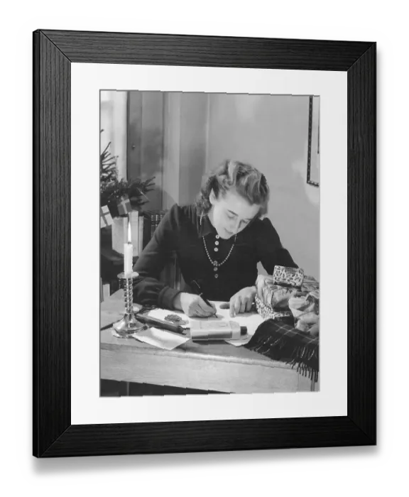 Framed Print : Christmas in the 1940s. A woman is wrapping christmas gifts Framed Print : Christmas in the 1940s. A woman is wrapping christmas gifts
