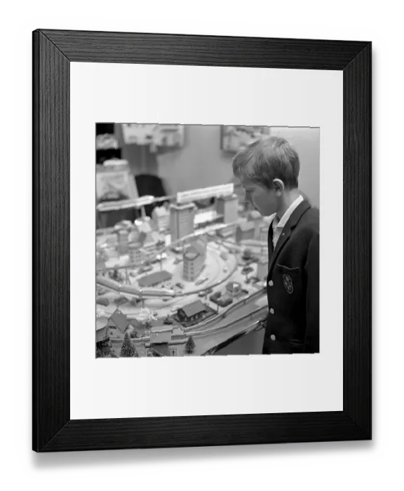 Framed Print : Toys in the 1960s. A boy at a model railway in a store