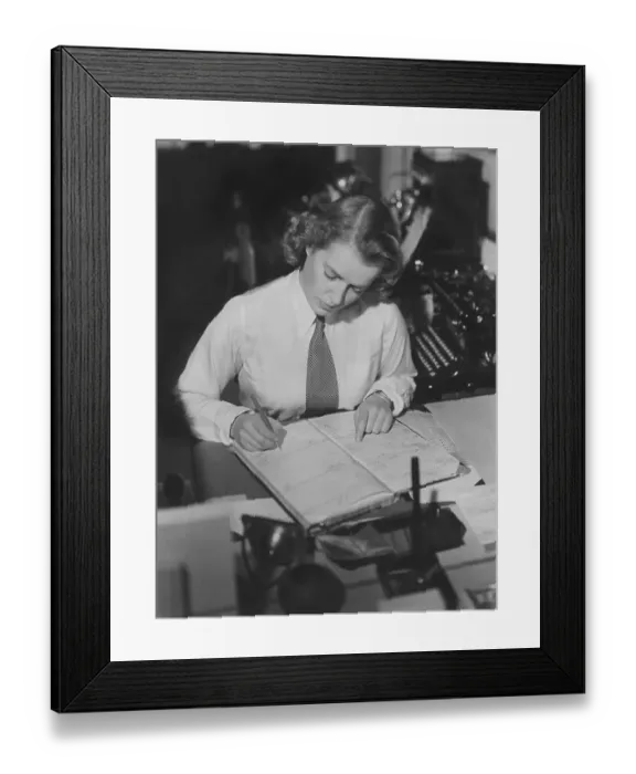 Framed Print : 1940s office clerk. A young woman in an office where she make careful notes in a registrer