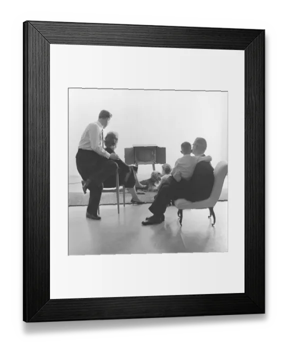 Framed Print : Television in the 1950s. Family in front of a television set and fascinated by the new television medium in March 1959