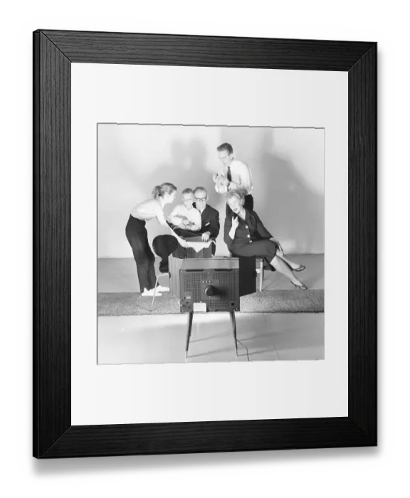 Framed Print : Television in the 1950s. Family in front of a television set and fascinated by the new television medium in March 1959