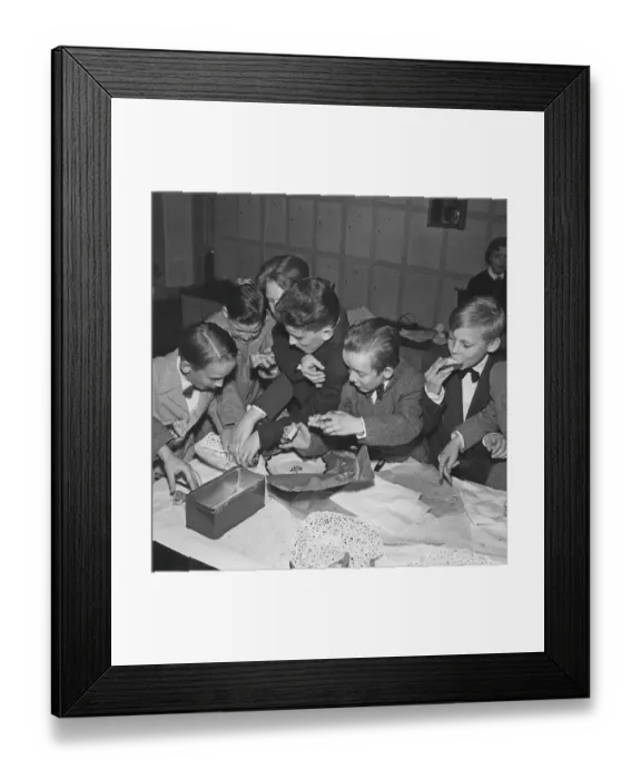 Framed Print : Children in the 1950s. A group of boys at a party are grabbing and fighting over the cookies and buns