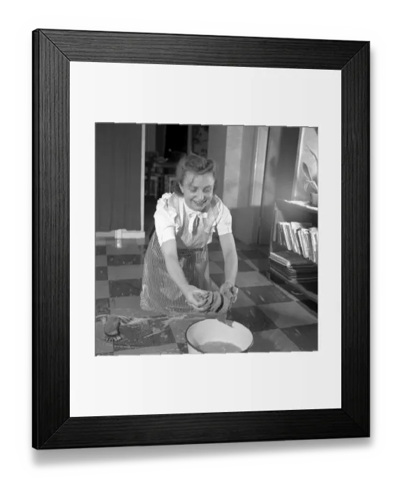 Framed Print : Cleaning the floor back then. A young woman is lying on the floor and is scrubbing to get the floor clean Framed Print : Cleaning the floor back then. A young woman is lying on the floor and is scrubbing to get the floor clean