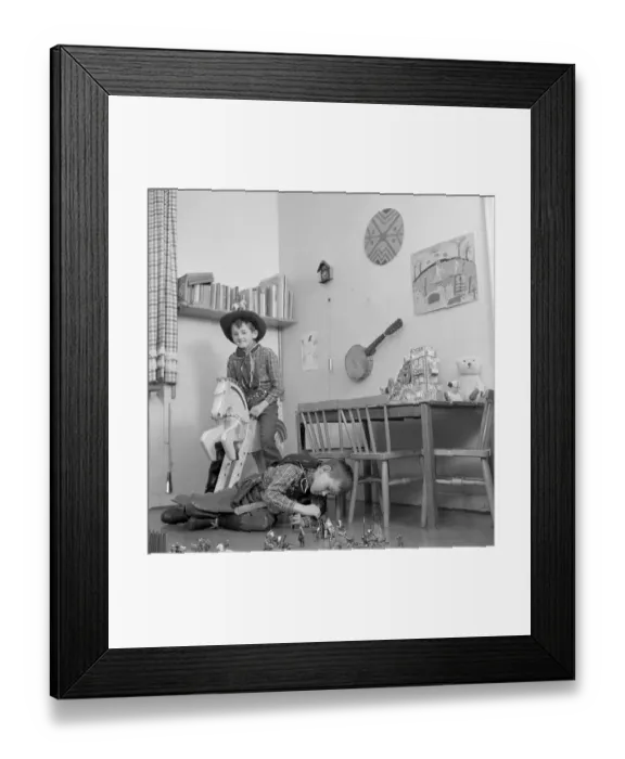 Framed Print : Boys in the 1950s. Two boys in their play room are dressed as cowboys