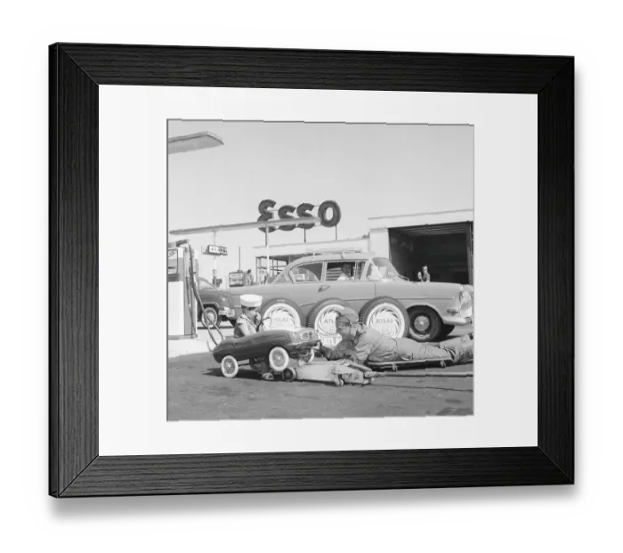 Framed Print : Service station of the 1950s. A boy in his pedal car has it serviced at an Esso petrol station