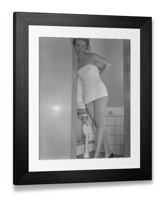 Framed Print : Having a bath 1950. A young smiling woman with a towel wrapped around her body is standing in the bathroom Framed Print : Having a bath 1950. A young smiling woman with a towel wrapped around her body is standing in the bathroom