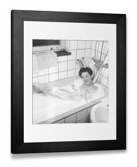 Framed Print : Having a bath 1950. A young smiling woman wearing a princess crown