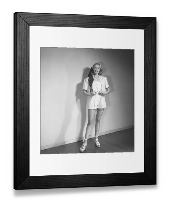 Framed Print : 1940s summer outfit. A young blonde woman wears a pair of whit shorts and a jacket Framed Print : 1940s summer outfit. A young blonde woman wears a pair of whit shorts and a jacket