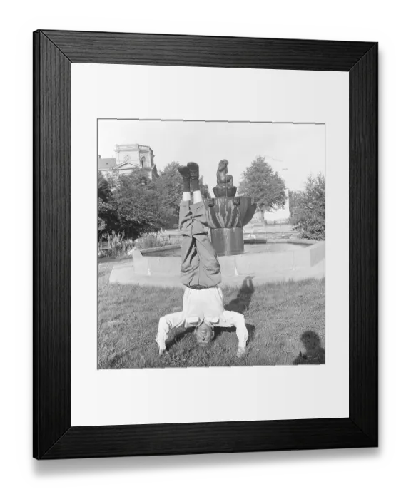 Framed Print : Man of the 1950s. A man is standing on his head balancing Framed Print : Man of the 1950s. A man is standing on his head balancing