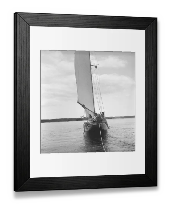 Framed Print : 1940s boating. Four young women are on board a fashionable sailing boat that is being towed