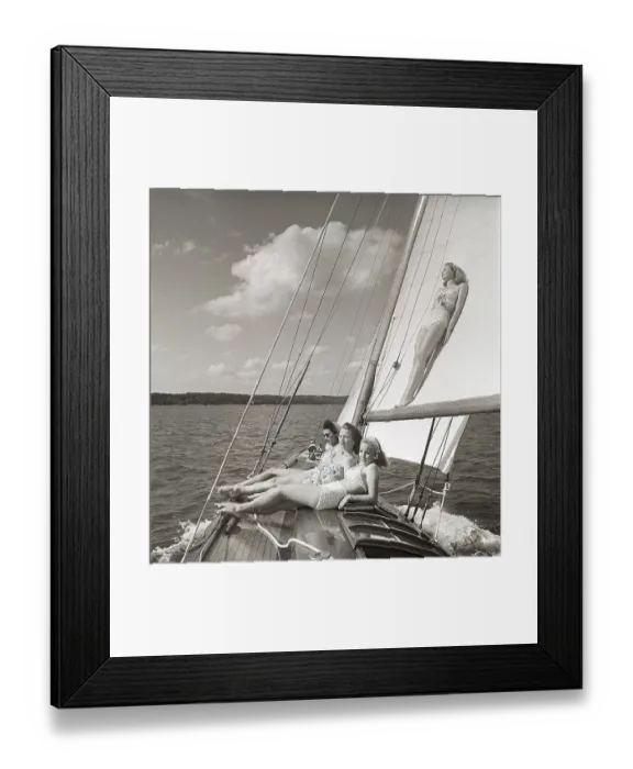 Framed Print : 1940s sailing boat. Four young women are aboard the sailing boat and enjoying the sunshine on deck Framed Print : 1940s sailing boat. Four young women are aboard the sailing boat and enjoying the sunshine on deck