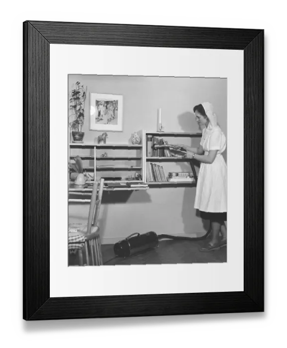 Framed Print : Vacuuming in the 1950s. The young student Gertrud Larsson is having a cleaning day in her student apartment