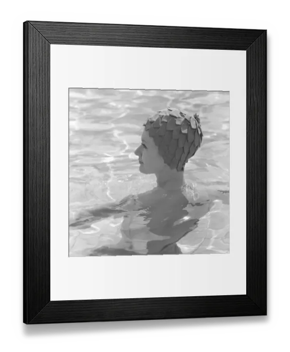 Framed Print : In the 1960s. A young woman pictured in the swimming pool wearing a typical 1960s bathing cap in a plastic material
