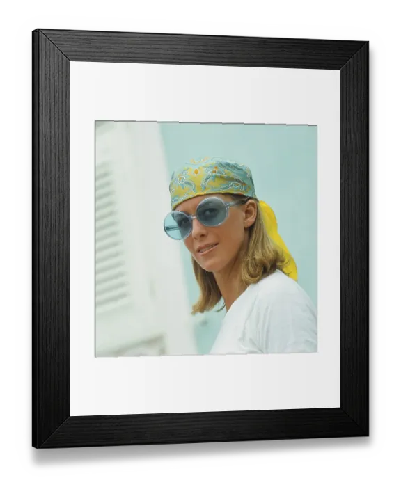 Framed Print : 1960s glasses. Summer of 69. The young female fashion model is wearing this years model of sunglasses and accessories