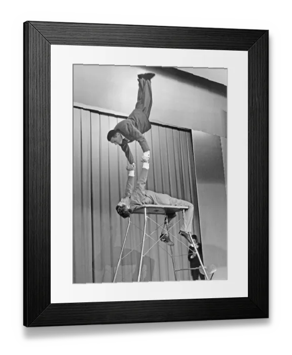 Framed Print : 1960s acrobatic show. The Two Apollos performs on stage in a balance and strenght act Framed Print : 1960s acrobatic show. The Two Apollos performs on stage in a balance and strenght act