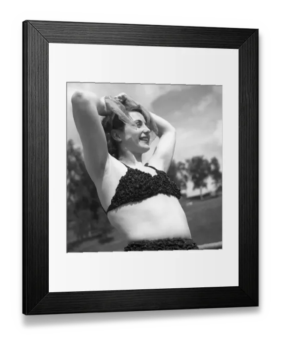 Framed Print : 1940s summer. A young woman in a bikini top