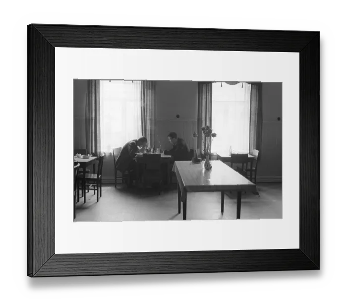Framed Print : Restaurant 1954. Two men sit together at a simple piece of furniture table and chairs having a meal Framed Print : Restaurant 1954. Two men sit together at a simple piece of furniture table and chairs having a meal
