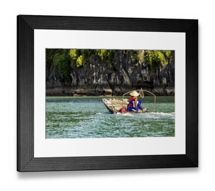 Framed Print : A dugout canoe with a seated person glides silently through clear