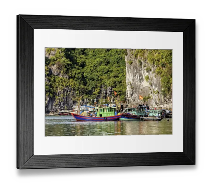 Framed Print : Colourful fishing boats lean against each other in the water Framed Print : Colourful fishing boats lean against each other in the water