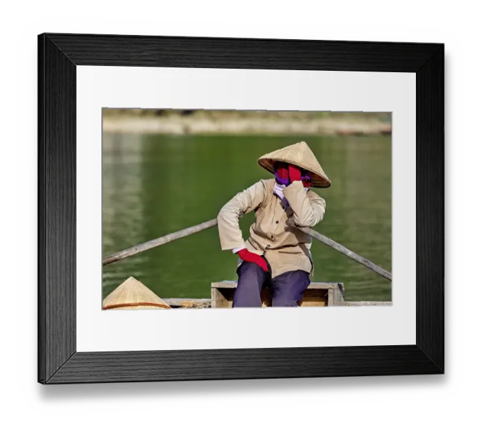 Framed Print : Person in traditional clothes relaxing on a boat on the river Framed Print : Person in traditional clothes relaxing on a boat on the river