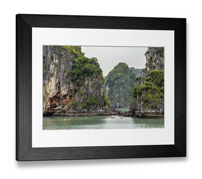 Framed Print : Majestic limestone cliffs surround calm waters as kayaks glide serenely through the scenery Framed Print : Majestic limestone cliffs surround calm waters as kayaks glide serenely through the scenery