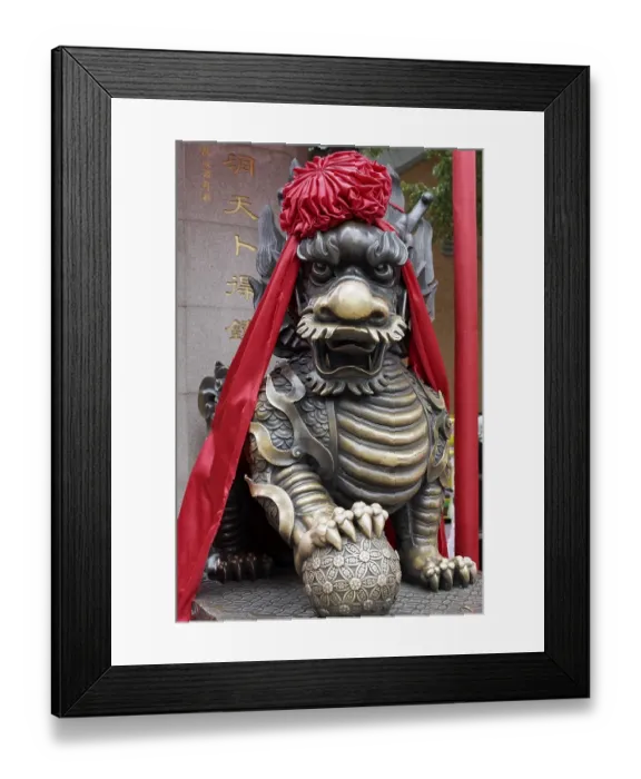 Framed Print : Guardian lion, decorated with red ribbon Framed Print : Guardian lion, decorated with red ribbon